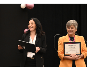 Dr. Susan Grove, Chief Development Officer, and Michelle Carroll Smith, Chief of Schools at Collegiate Edu-Nation, present The Moody Foundation grant awards during the Awards Luncheon at the Rural Empowerment Conference.